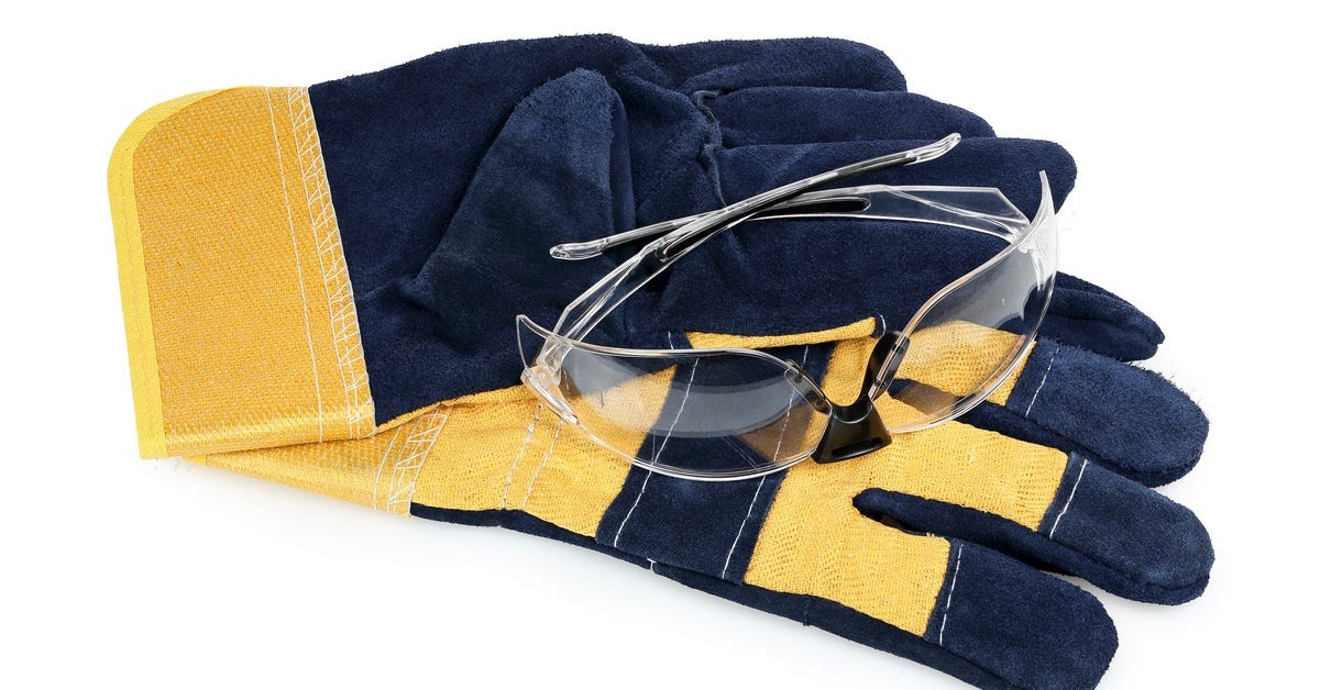 A closeup of a diamond saw blade with water droplets and a gray tile. The grooves appear to have gone through use.